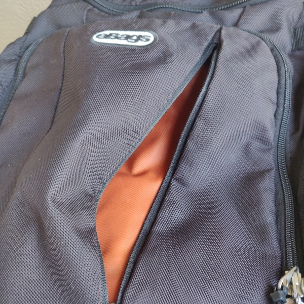 eBags Mother Lode front zipper opened to reveal high-visibility orange liner