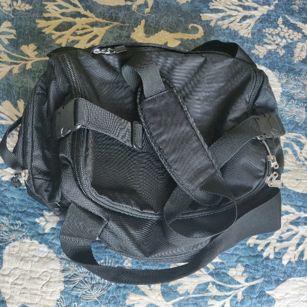 black eBags Mother Lode Duffle bag with the crossbody strap attached