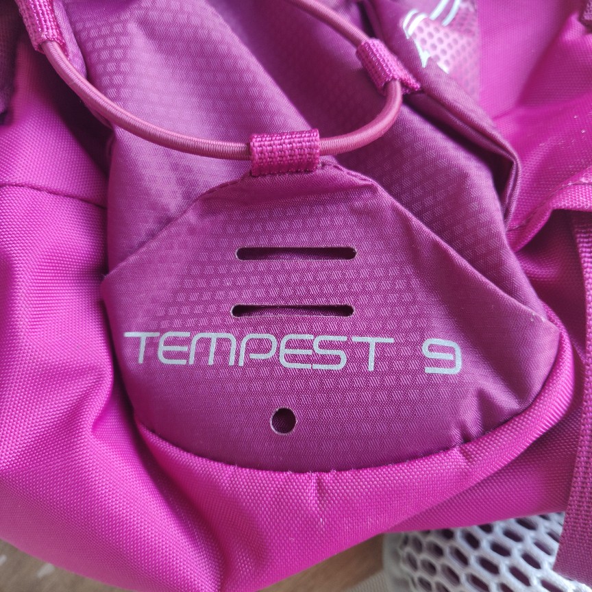 branding of Osprey Tempest 8 women's hiking backpack in "Magnificent Magenta" colorway
