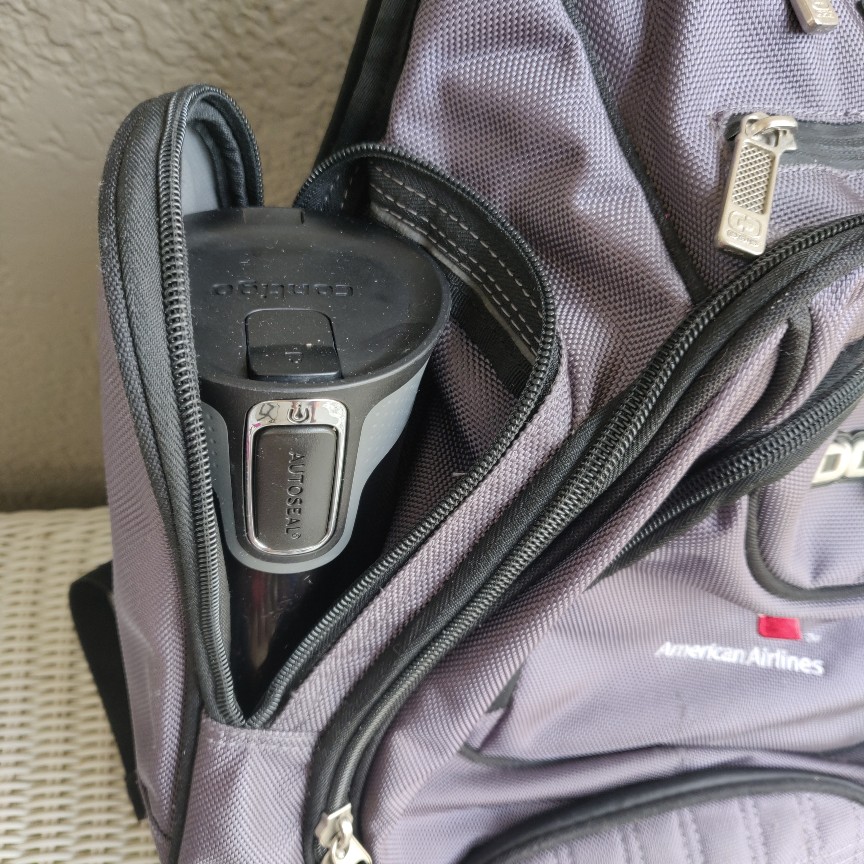Silver OGIO Metro Backpack with unzipped external water bottle pocket