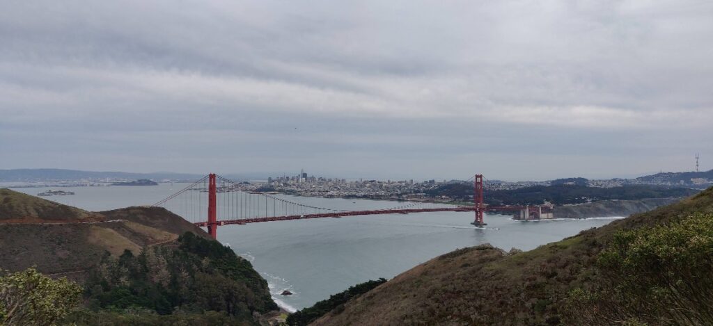 Picture of Golden Gate Bridge from the Marin side of the bridge. Skyline of San Francisco in distant background