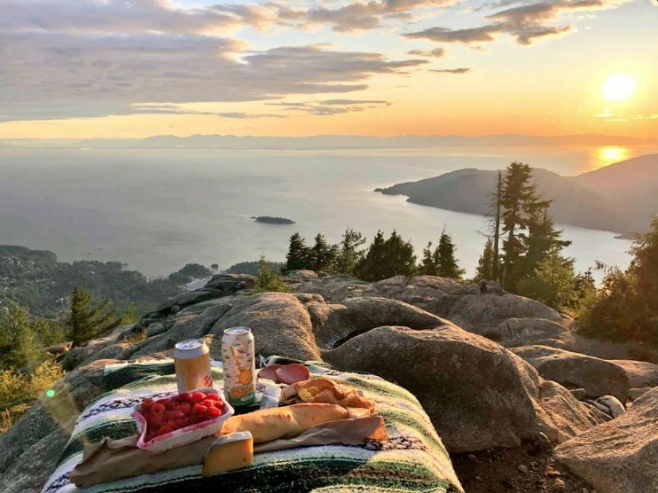 A picnic spread spread across a blanket at the top of Eagle Bluffs in West Vancouver