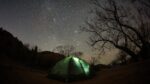 nighttime shot of tent in foreground with the night sky full of stars in background. Shot taken while camping in Palo Duro Canyon