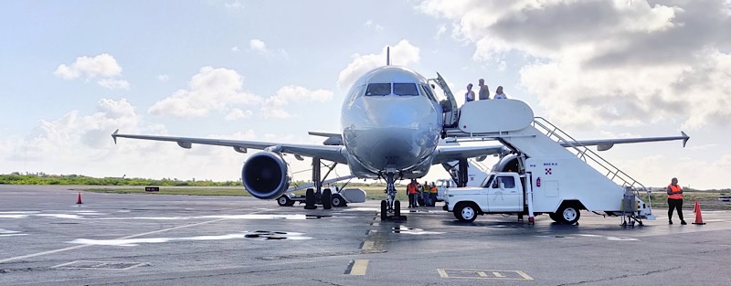 head-on view of an A319 being deplaned in Bonaire's Flamingo International Airport