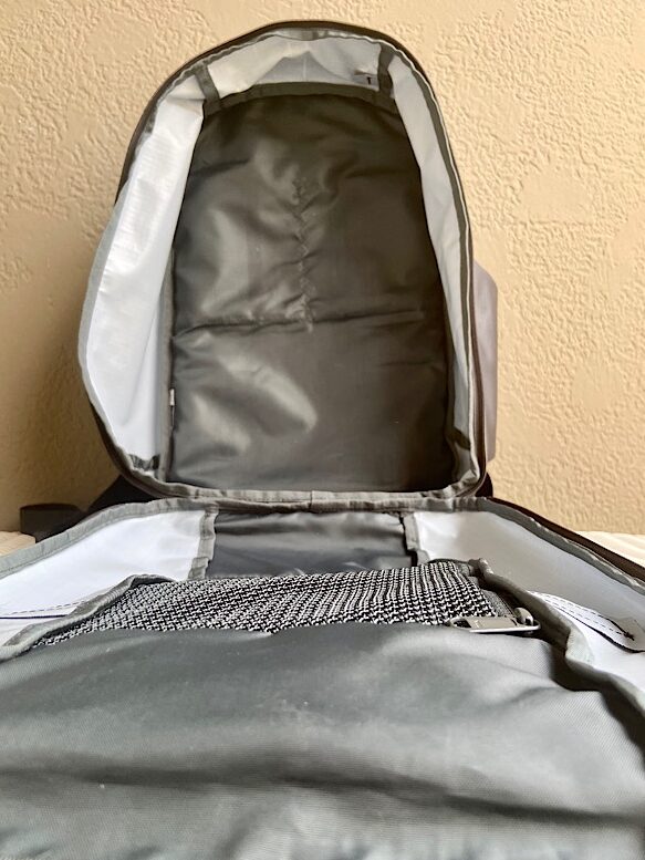 Empty clamshell-style backpack showing open compartment