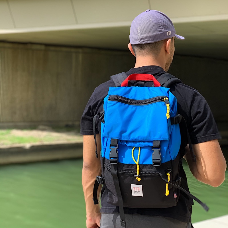 Man wearing Rover Pack Classic in front of a water canal