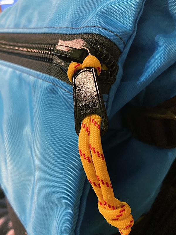 YKK zipper with a yellow ripcord zipper pull