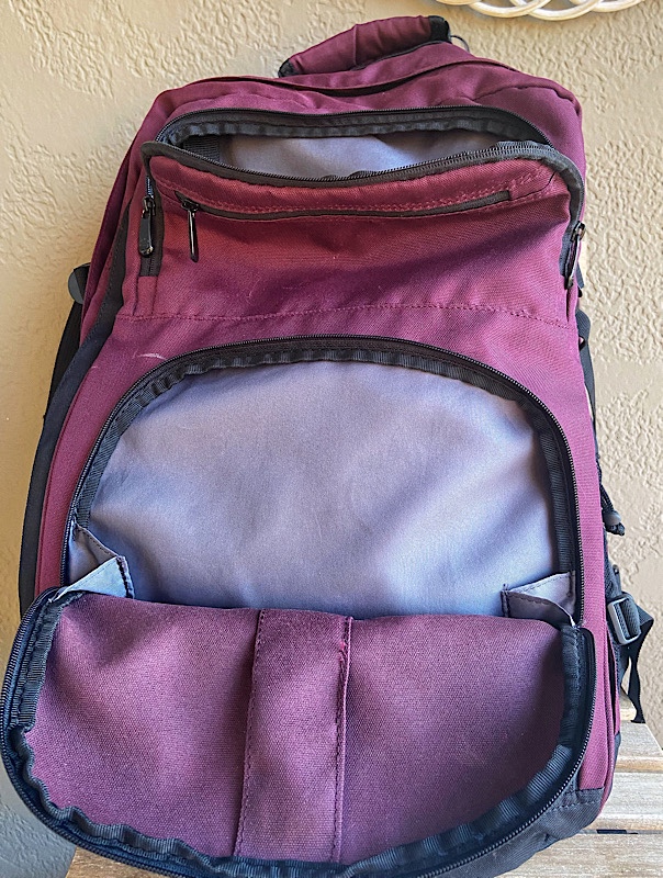front of backpack with the zipper pockets opened to reveal large storage spaces