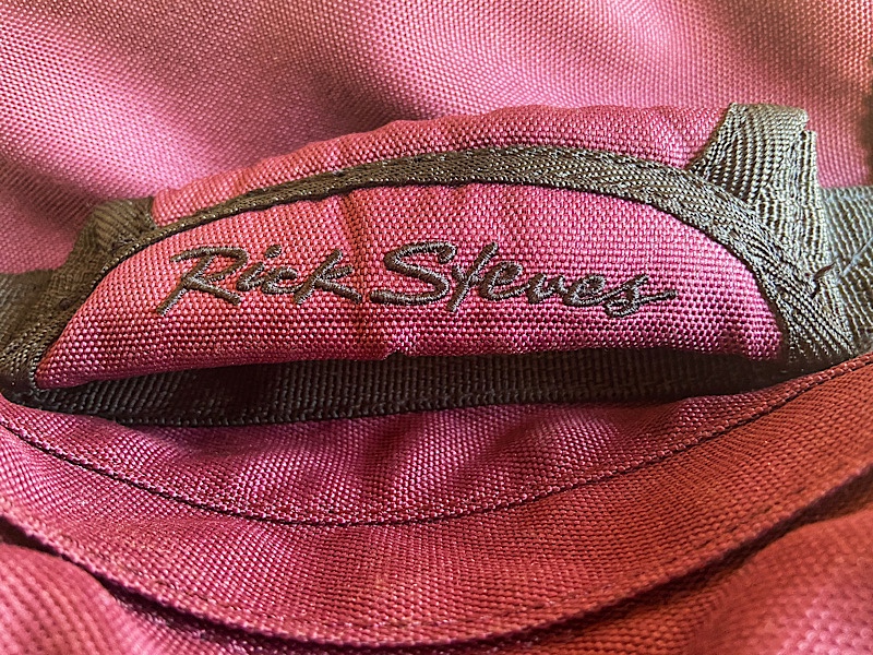 Rick Steves' brand name stitched onto the padded grab handle