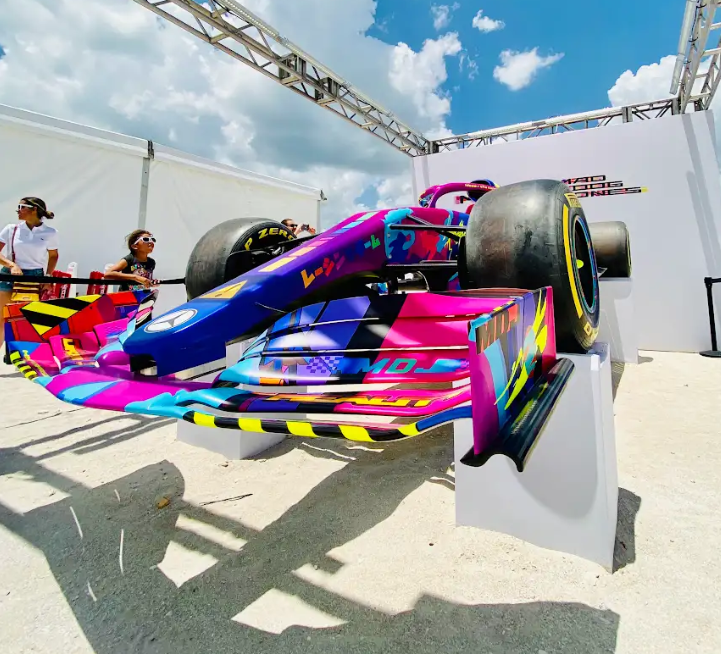 brightly colored Mercedes showcar on a beach